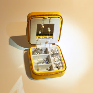 Featuring separate compartments for earrings, necklaces/bracelets, rings and pendants lined with suede.