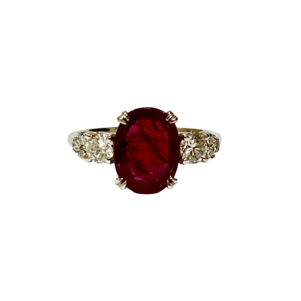 A 9ct white gold ring with a double claw set ruby and brilliant cut diamonds