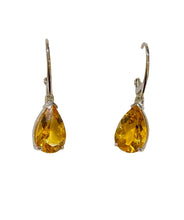 Pair of yellow teardrop earrings on a light gray background