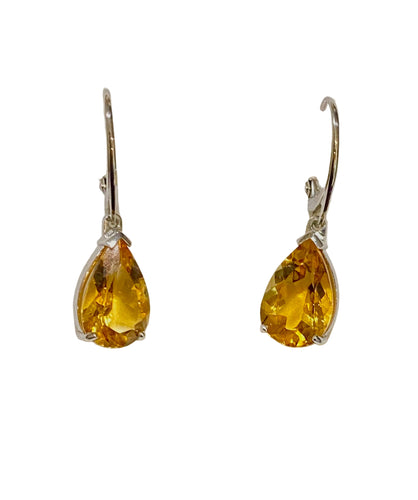 Pair of yellow teardrop earrings on a light gray background