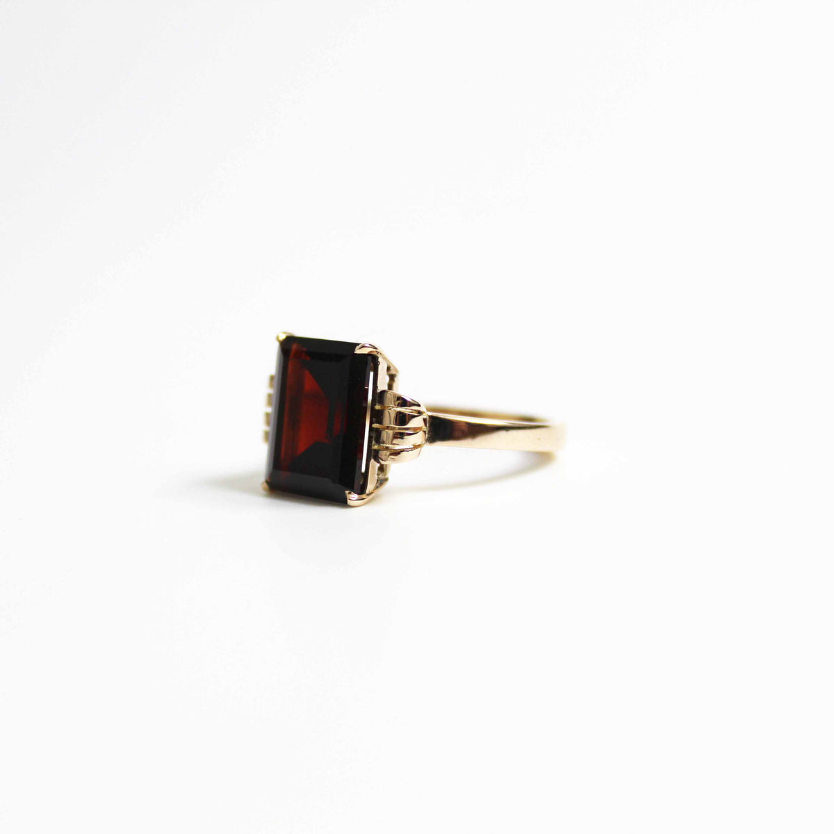 Art Deco Style Garnet Ring With Elaborate Side Scrolls